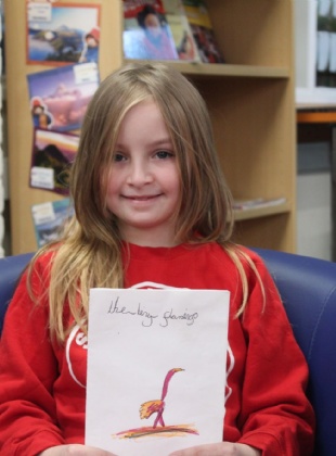 Girl smiling sitting in a school library 