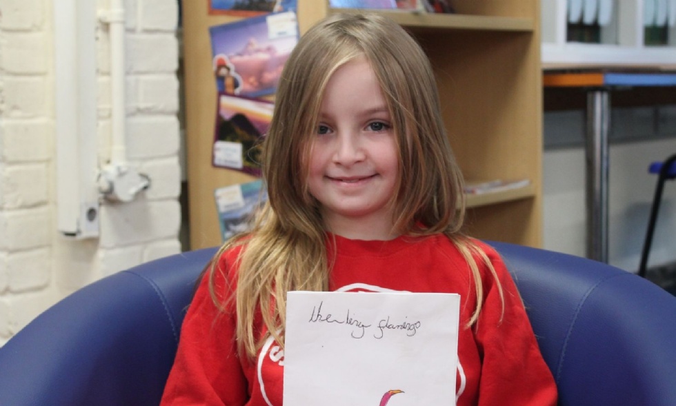 Girl smiling sitting in a school library 